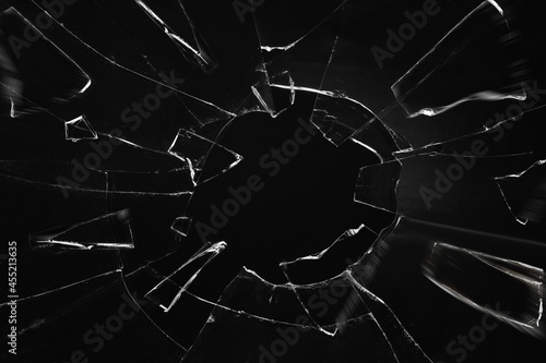 Broken glass with cracks on black background