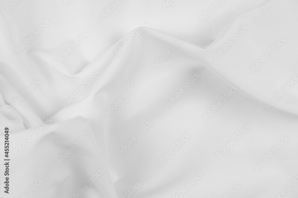 Abstract white fabric texture background. Cloth soft wave. Creases of satin, silk, and cotton.