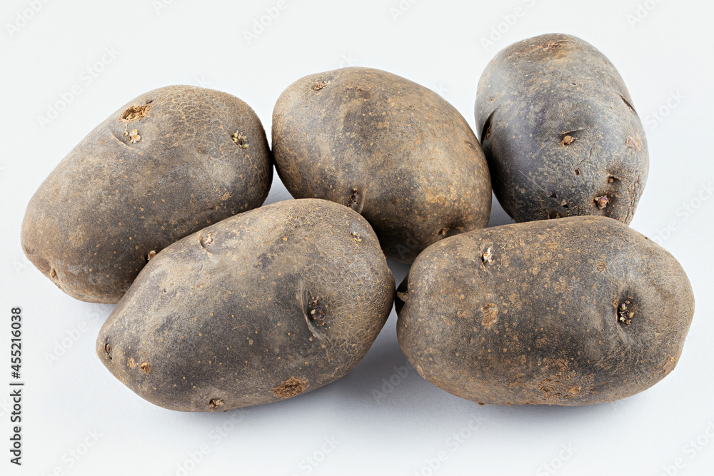 Fresh purple potatoes isolated on a white background. Fresh purple potatoes isolated on a white background.