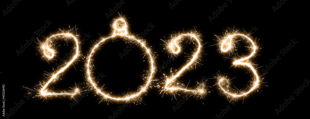 The 2023 lettering is made with sparklers isolated on black background. The 2023 lettering is made with sparklers isolated on black background.