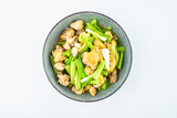 Chicken with celery on a dish on white background