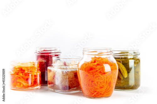 Fermented, probiotic food on a white background. Canned vegetables. Pickled carrot, sauerkraut and other organic preserves in mason jars. Healthy vegan cooking concept with copy space