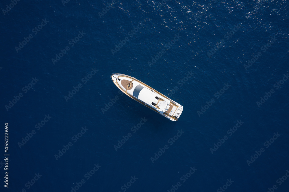 Fototapeta premium Super yacht on blue water top view. Huge white super Mega yacht on blue water in Italy. White sport yacht open sea aerial view.