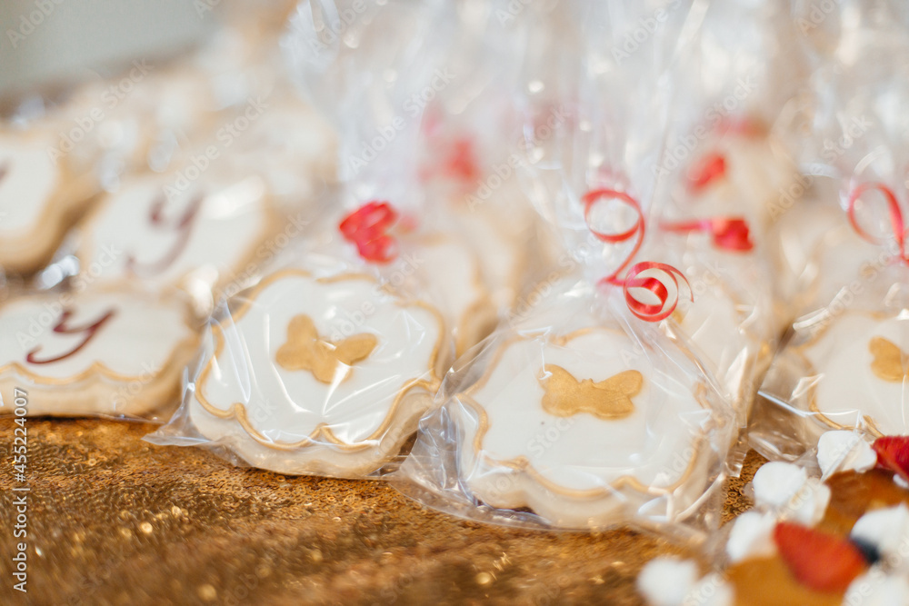 Red and gold festive decoration. Cookies, flowers, food on the birthday table. Wedding table. Festive background Red and gold festive decoration. Cookies, flowers, food on the birthday table. Wedding table. Festive background