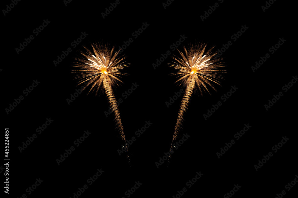 Fireworks of various colors bursting against a black background