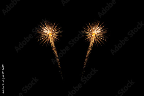 Fireworks of various colors bursting against a black background