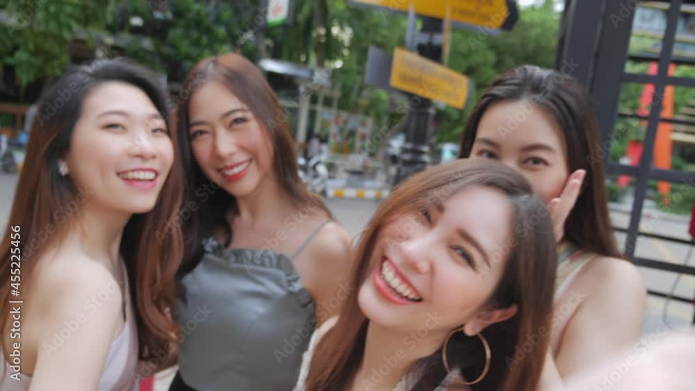 Group of young woman Asian people is taking selfie looking camera at urban city street. City lifestyle of young women group on weekend. Outdoor shopping and city lifestyle concept. Group of young woman Asian people is taking selfie looking camera at urban city street. City lifestyle of young women group on weekend. Outdoor shopping and city lifestyle concept.