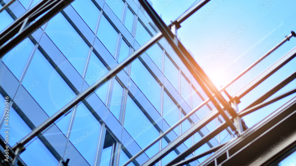 Fragment of glass and metal facade walls. Commercial office buildings. Abstract modern business architecture. Fragment of glass and metal facade walls. Commercial office buildings. Abstract modern business architecture.