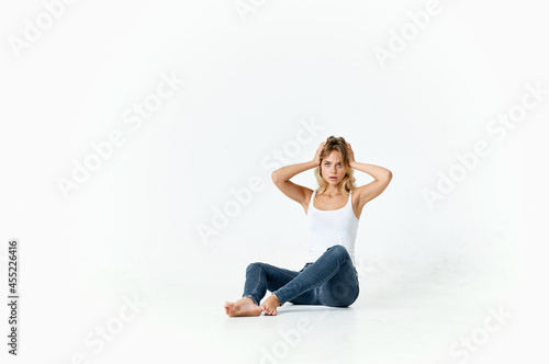 woman sitting on the floor posing fashion stylish hairstyle lifestyle