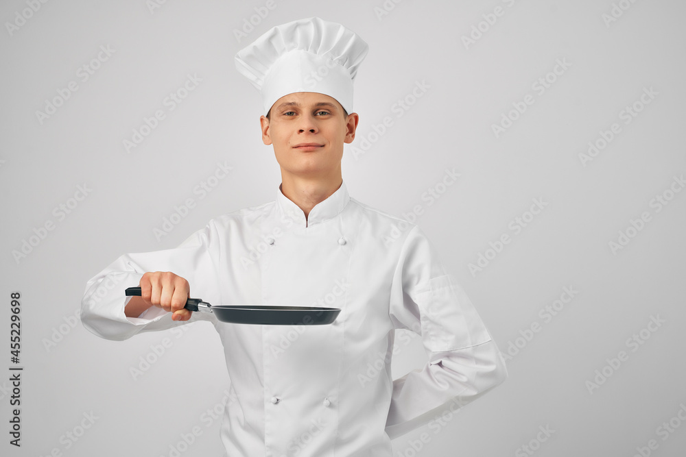 man in chef's clothes frying pan in hands professional kitchen work man in chef's clothes frying pan in hands professional kitchen work