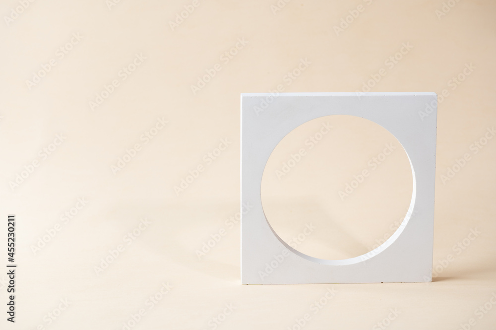 White podium on beige background. Template, mock up for presentation products. Pastel colors styled composition with geometrical forms. Minimal concept. Product podium. White podium on beige background. Template, mock up for presentation products. Pastel colors styled composition with geometrical forms. Minimal concept. Product podium.