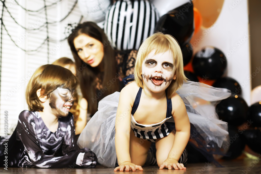 happy family with childrens in costumes and makeup on a celebration of Halloween happy family with childrens in costumes and makeup on a celebration of Halloween