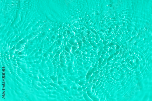 Water tranquil ripple background. Water texture, circles and bubbles on a liquid blue surface. Cosmetic products and flat design concept