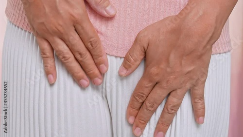 Female hands scratching crotch with leucorrhoea, vaginitis, problems of bacterial vaginosis, vaginal itching and unpleasant smell. Gynecological and health care concept. photo