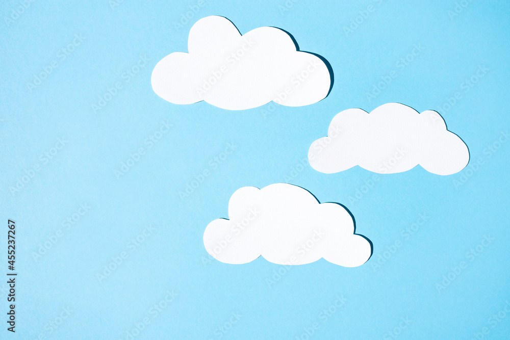 Clouds of white paper on a blue background. Flat lay, place for text.