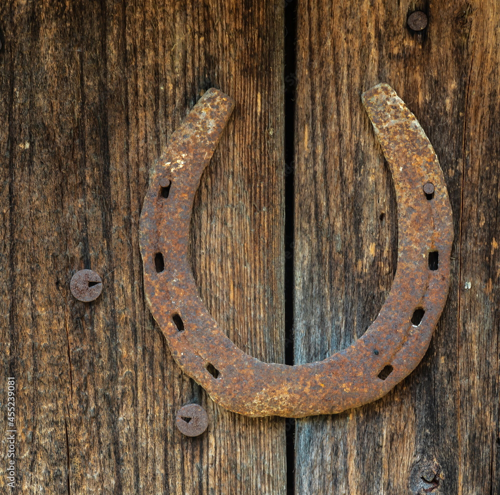 horseshoe for good luck on the old wooden door horseshoe for good luck on the old wooden door