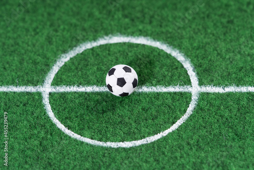 Black and white soccer ball in the center of the soccer field, decoration mini football.