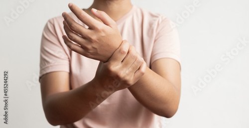 woman hand with numbness and pain in the wrist has pain and tingling in the nerve endings. which is a side effect of Guillain-Barre Syndrome after vaccination against COVID-19