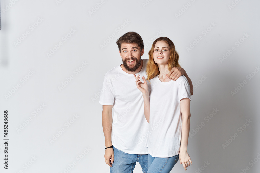 cheerful young couple in white t-shirts emotions studio advertising design cheerful young couple in white t-shirts emotions studio advertising design