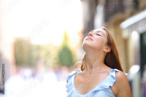 Woman is breathing fresh air in the street