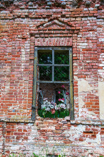 an old window in the brick wall of an abandoned church