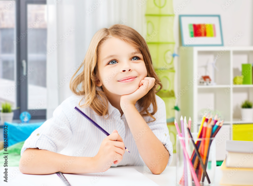 education and school concept - happy student girl drawing with pencils over home room background education and school concept - happy student girl drawing with pencils over home room background