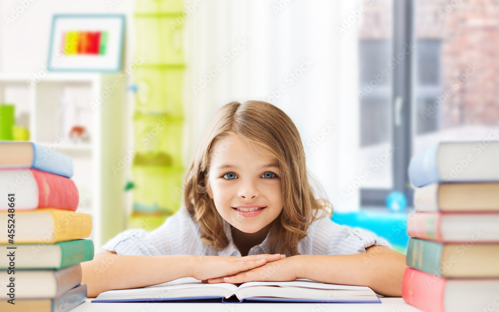 education and school concept - happy smiling student girl with books learning over home room background education and school concept - happy smiling student girl with books learning over home room background
