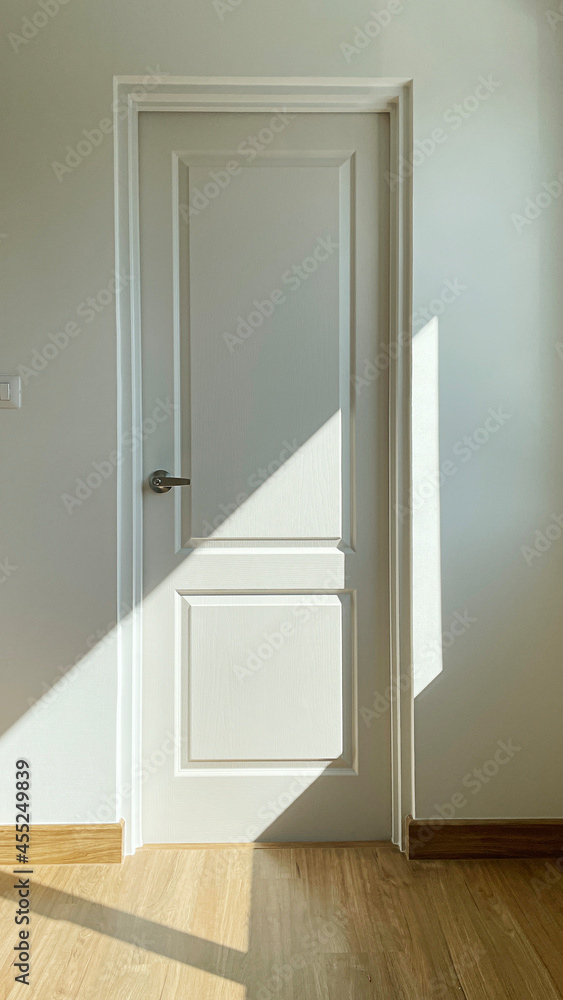 Closeup detail of white door with shadow. Closeup detail of white door with shadow.