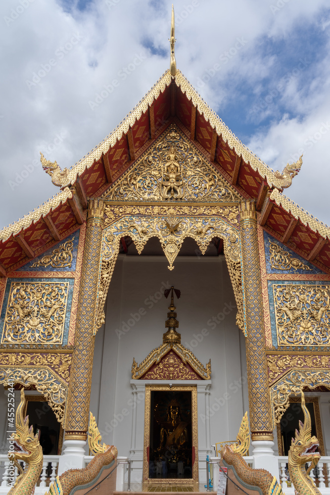 View of Viharn Luang or main vihara facade with beautiful golden wood carving at famous landmark Wat Phra Singh buddhist temple, Chiang Mai, Thailand