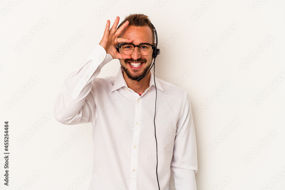 Young caucasian telemarketer man with tattoos isolated on white background excited keeping ok gesture on eye. Young caucasian telemarketer man with tattoos isolated on white background excited keeping ok gesture on eye.