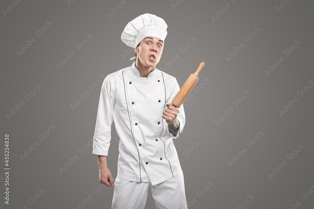 Angry young chef with rolling pin