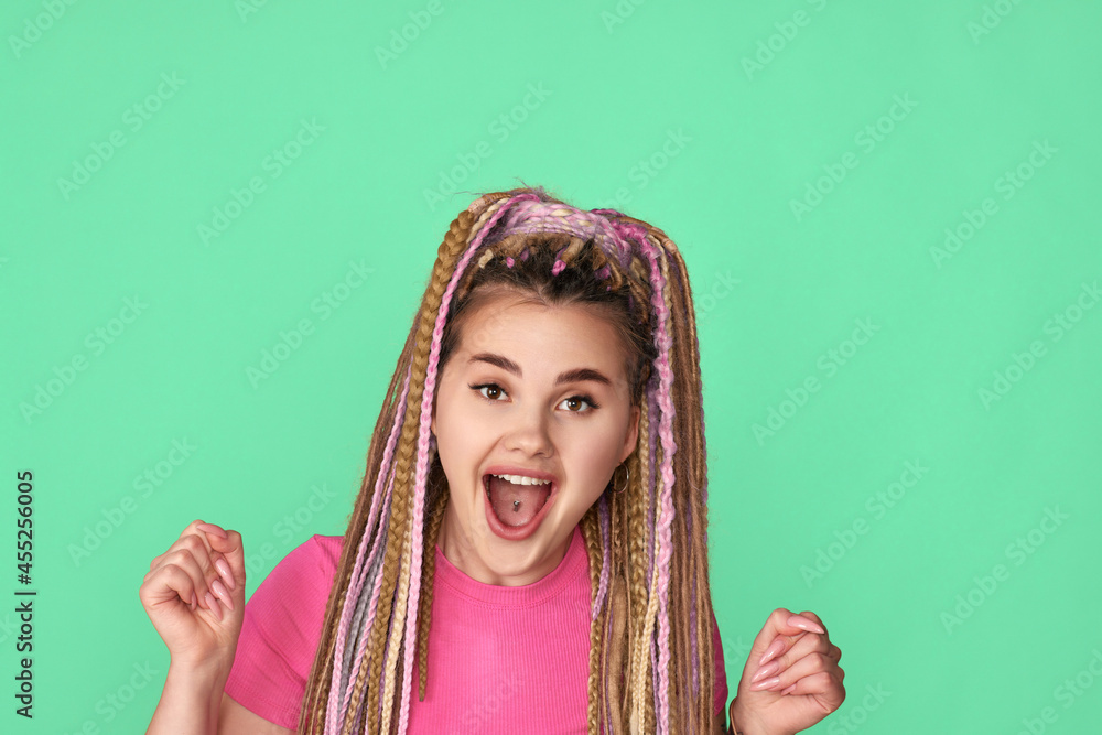 surprised woman with dreadlocks on green background. surprised woman with dreadlocks on green background.
