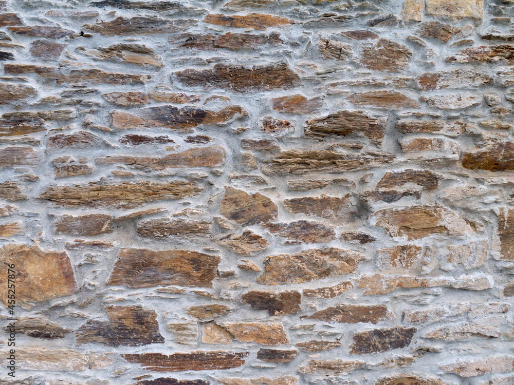 Ancient natural brown stone wall background Ancient natural brown stone wall background