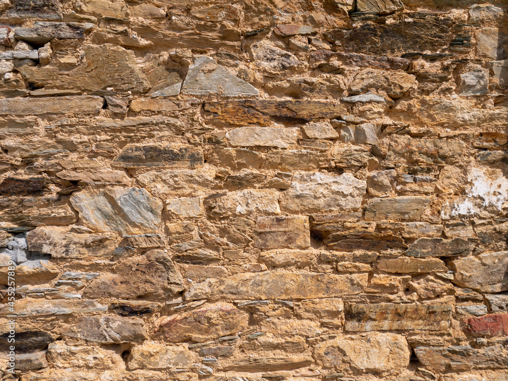 Natural bright yellow limestone wall background Natural bright yellow limestone wall background