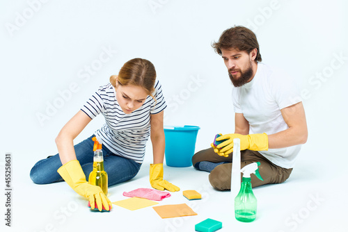 Man and woman near the sofa room cleaning provision of services