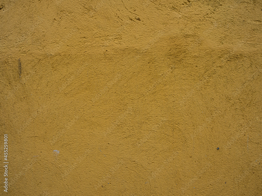 The texture of a plastered yellow wall The texture of a plastered yellow wall