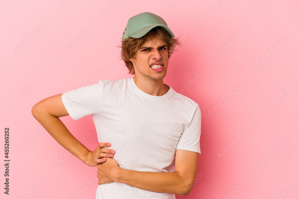 Young caucasian man with make up isolated on pink background having a liver pain, stomach ache. Young caucasian man with make up isolated on pink background having a liver pain, stomach ache.