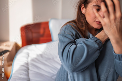 Upset woman crying in bed