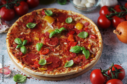 Pizza with salami and basil 
