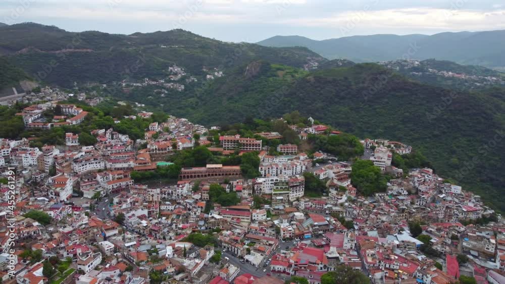 High aerial view of the city of Taxco de Alarcon and the surrounding mountain terrain. High aerial view of the city of Taxco de Alarcon and the surrounding mountain terrain.