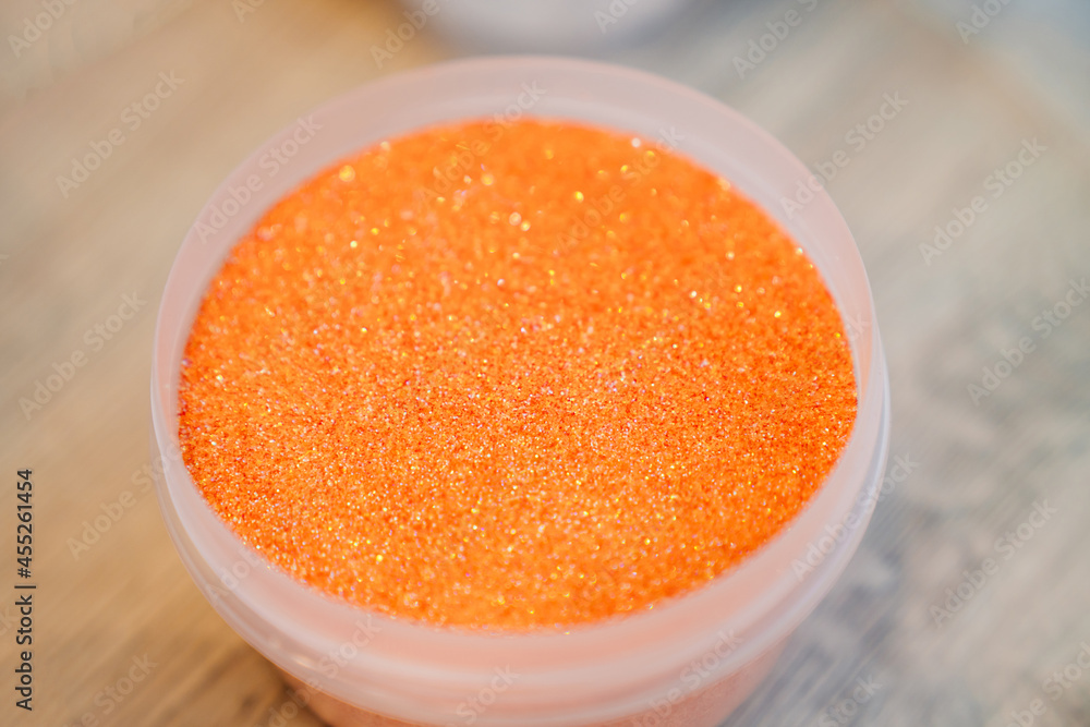orange sand in a container for crafts and souvenirs. orange sand in a container for crafts and souvenirs.