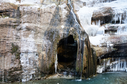 Frozen waterfall and entrance to the rock-ice grotto photo