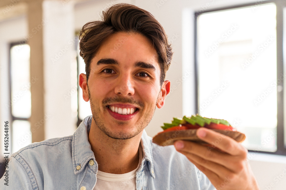 Young mixed race man having breakfast in his kitchen Young mixed race man having breakfast in his kitchen