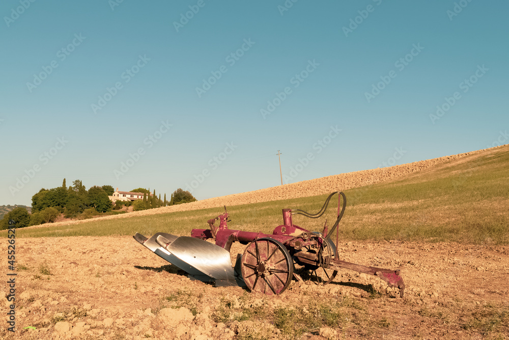Closeup of a plow standing on a hill in the idyllic Tuscan countryside