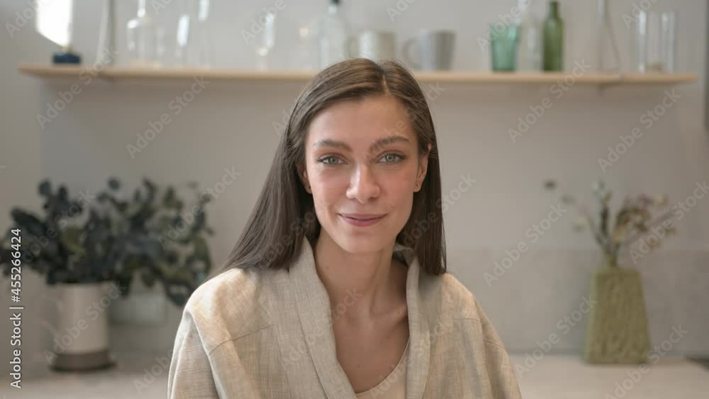 Attractive brunette woman laughing, looking at the camera, takes a yellow pepper and smell it. Food blogger, vegan on background of kitchen decoration, gimbal shot Attractive brunette woman laughing, looking at the camera, takes a yellow pepper and smell it. Food blogger, vegan on background of kitchen decoration, gimbal shot