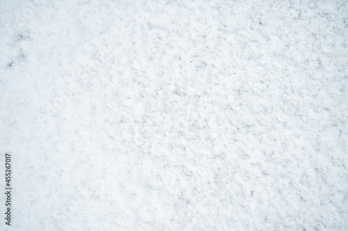 The texture of white untouched snow lying on the road