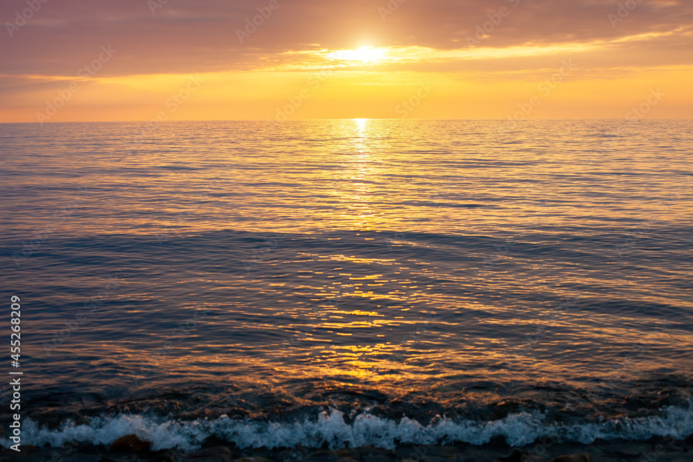 Amazing beach sunset with endless horizon. Horizontal. Selective focus.