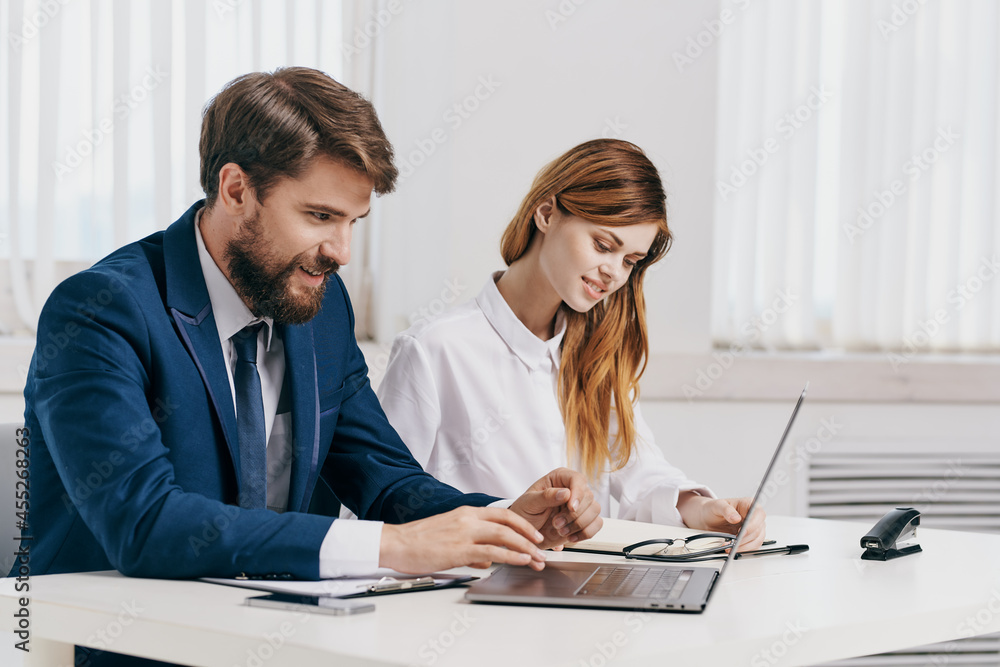 business man and woman sitting at the table in front of laptop professionals technology business man and woman sitting at the table in front of laptop professionals technology