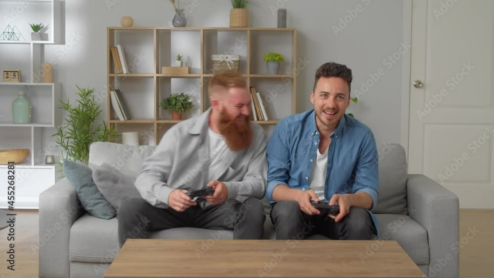 Caucasian Friends With Joystick Playing Video Games At Home Caucasian Friends With Joystick Playing Video Games At Home