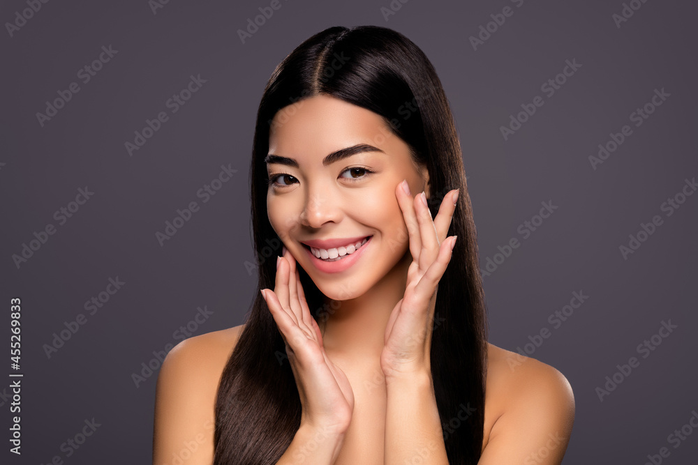 Photo of relaxed joyful dreamy korean brunette lady fingers cheekbones white smile isolated grey color background Photo of relaxed joyful dreamy korean brunette lady fingers cheekbones white smile isolated grey color background